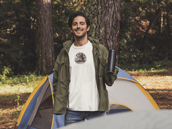 man wearing white tshirt with vintage photo print of a bear on back legs and the text do not feed the bears