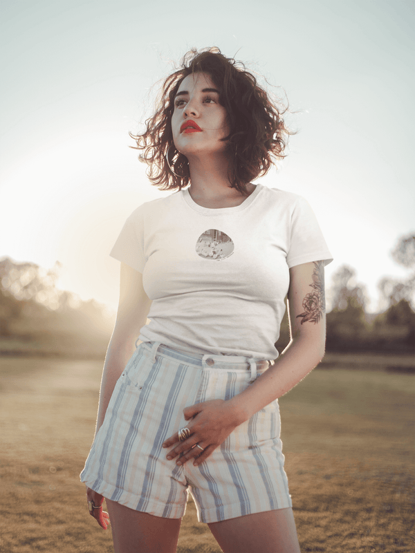 woman wearing white tshirt with vintage photo of chickens and the text the plot chickens