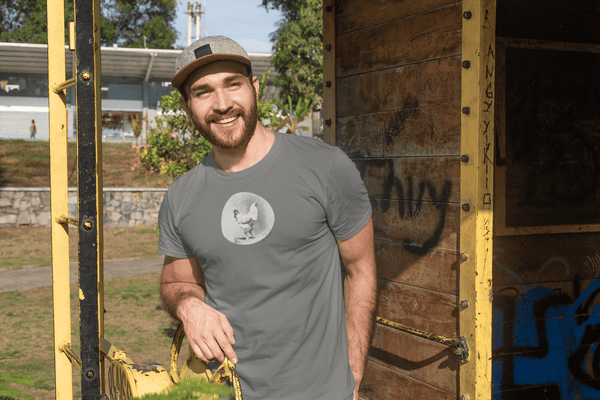 man wearing heather grey tshirt with vintage photo print of a rooster and the text oh cluck