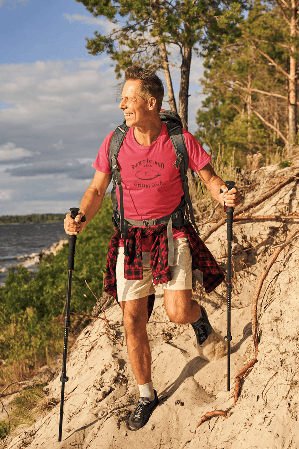 man hiking and wearing heather red mens tshirt with vintage graphic logo print of clam chowder brand