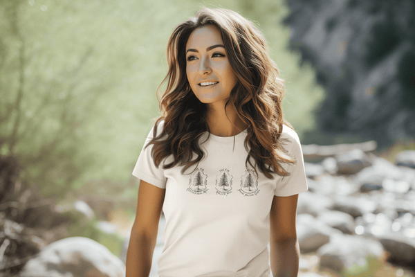 woman wearing white womens tshirt with vintage graphic logo of fire tree company brand with three fir trees