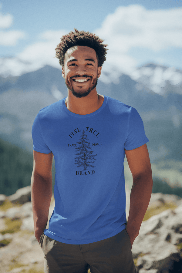 man wearing heather royal mens tshirt with vintage graphic logo print of three pine trees and the pine tree brand